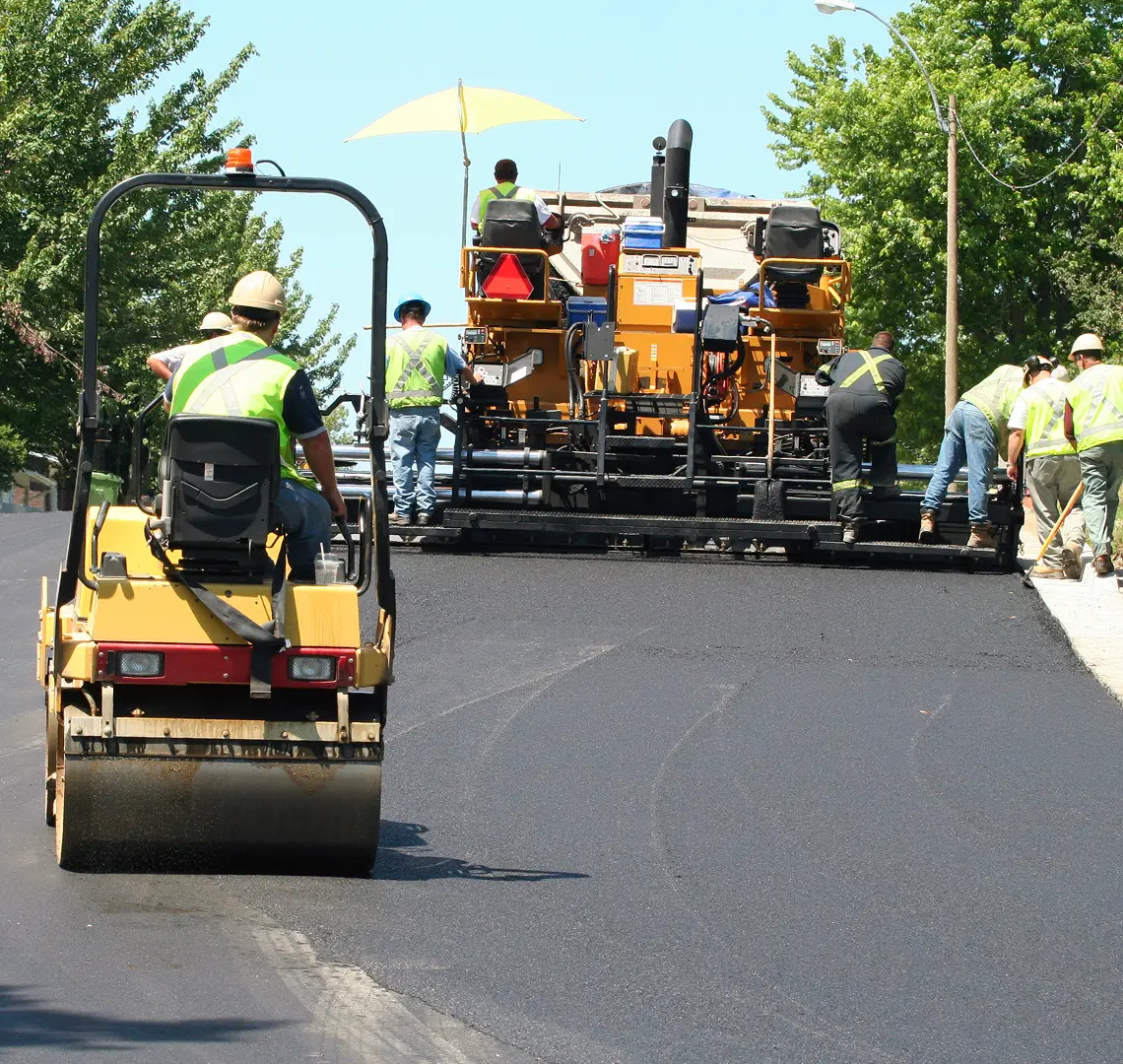 Rectangle 1174 (6) Road construction workers paving new asphalt.