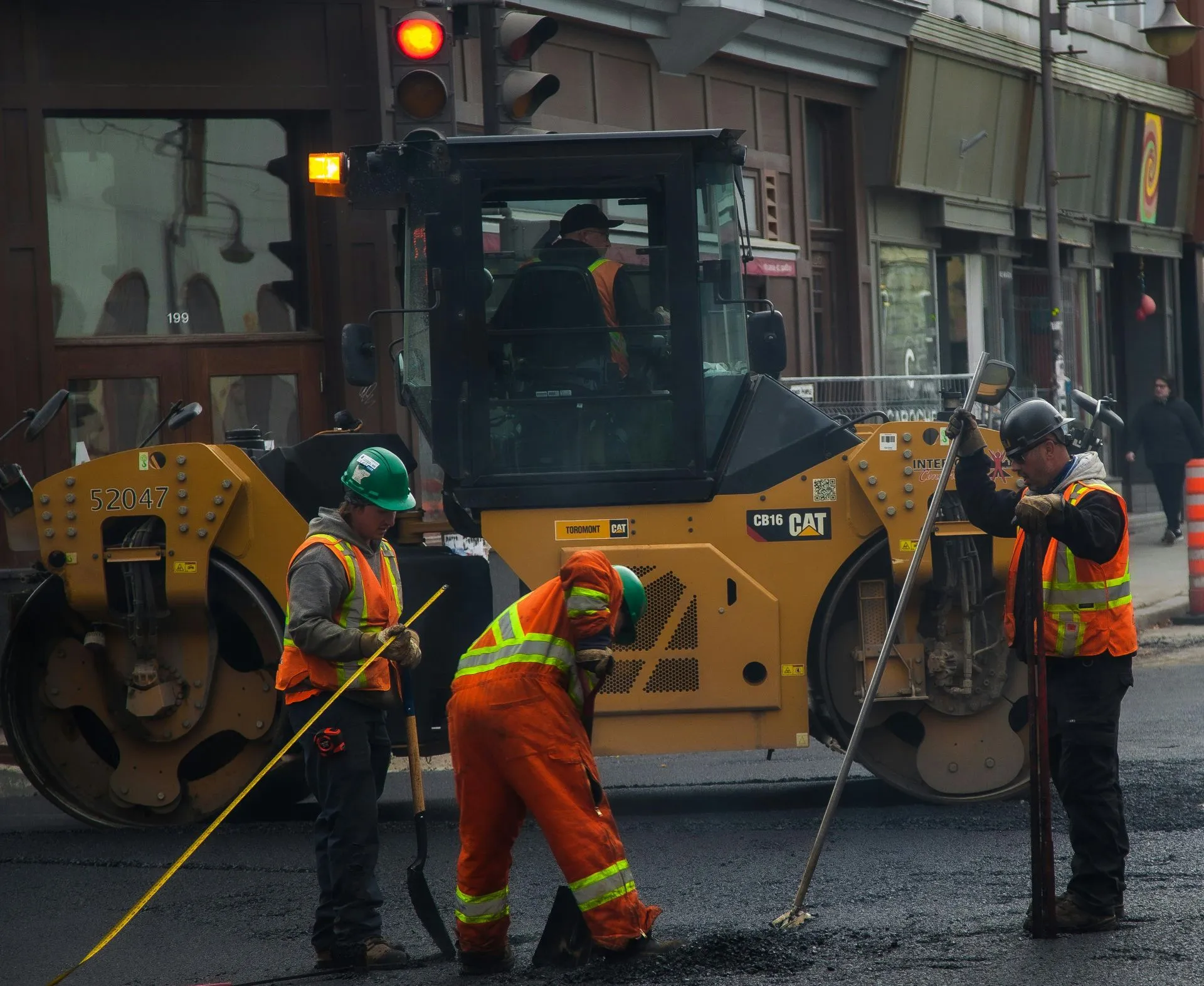 asphalt+repair+services+in+trinity+nc-8d5e0aef-1920w Construction workers repairing road with heavy machinery.