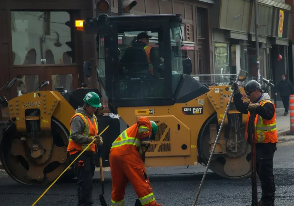 asphalt+repair+services+in+trinity+nc-8d5e0aef-1920w Construction workers repairing road with heavy machinery.